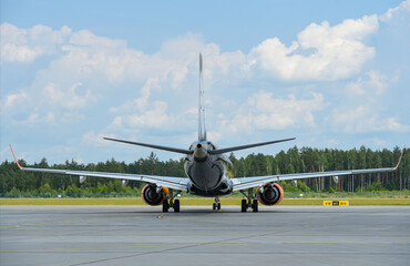 The passenger plane leaves the runway at the airport, rear view