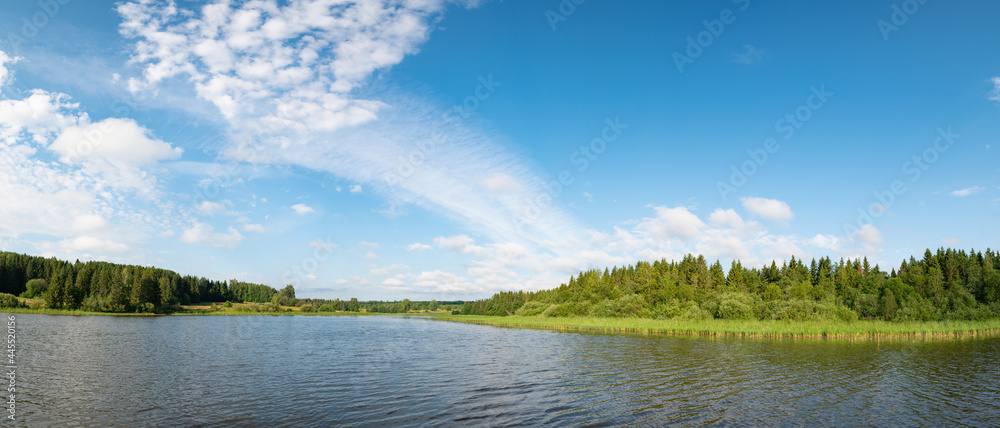 Wall mural panoramic landscape of a calm river. reflection of clouds on the lake.