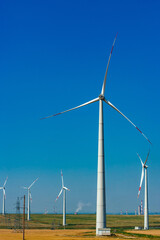 Wind electricity generator in summer fields, power plant, wind efficiency