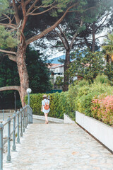 young pretty woman walking by sea quay