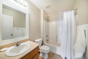 Interior of a bathroom with white wooden panel and set of shower tub kit
