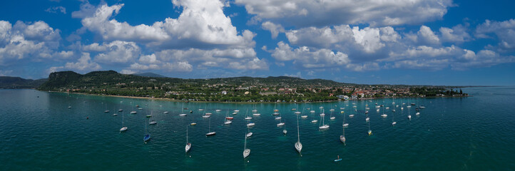 Historic town of Bardolino on Lake Garda, Italy. Bardolino, panorama aerial view of sailing boats....