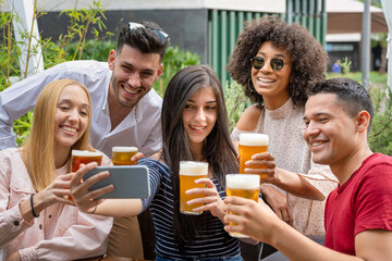 young adult people making selfie at the beer pub, mixed race group of friend having fun and using smart phone to connect to the world with social network app, mobile addicted person