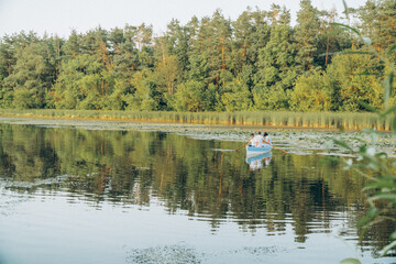 family on a boat sail on the lake