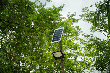 Street lighting pole with photovoltaic panel and LED lamp lights.