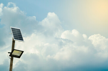 Street lighting pole with photovoltaic panel and LED lamp lights.