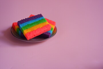 a plate of slices of rainbow cake