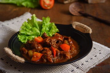 a plate of chicken meat cooked in spicy 