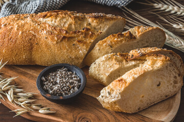 Mediterranean baguette with herbes and sel de mer on a wooden board