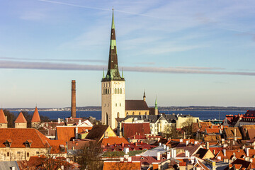 Fototapeta na wymiar Tallinn, Estonia. Aerial view at sunset of the Old Town with the Church of St Olaf and the towers. A World Heritage Site