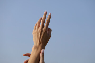 Fototapeta na wymiar hands in the sky. Love concept. Sensual. Cream. Woman hand