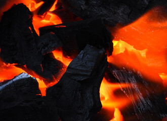Charcoal is burning red and smoke