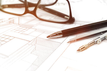 Drawings and plans for house construction background with pencil and glasses on office table