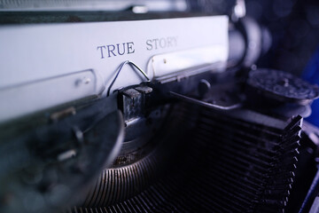 Fototapeta na wymiar old typewriter on table, words true story are printed on paper in large size, retro style, concept of writer, journalist, private detective