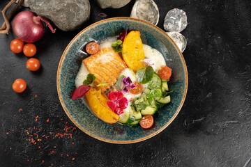Salmon with fried orange and broken cucumber