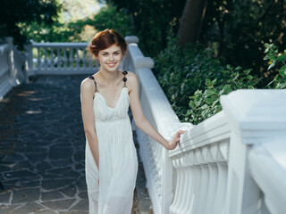 beautiful greek woman in a white dress in the park luxury mythology princess