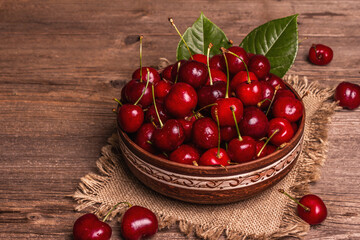 Fresh ripe sweet cherries in a bowl with droplets of water