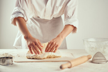 Obraz na płótnie Canvas kneading dough in the kitchen rolling pin baking homework