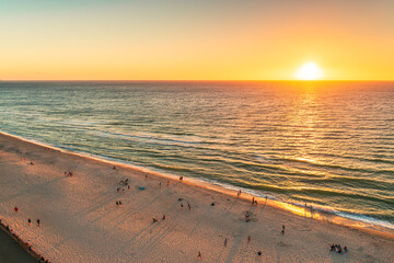 Glenelg beach with people at sunset viewed from above, South Australia