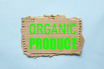 Organice Product. text on torn paper on blue background