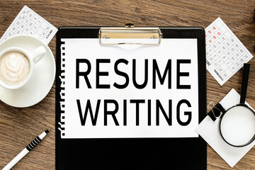 RESUME WRITING, text on wood table, on white paper