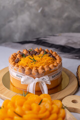 Thai tea layer cake decorated with white ribbon for birthday cake on wooden board, style Thai cake.