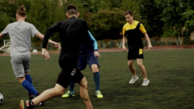 Football club training. Players work out a game moment on the football field. Slow motion