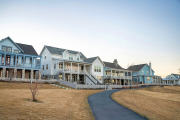 Row of large houses with curved paved road at the front