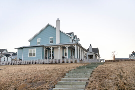 Large Two-storey Light Blue House On Top Of A Hill