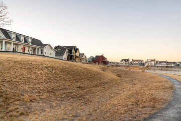 Residential community on top of a grassy field with colorful buildings of houses