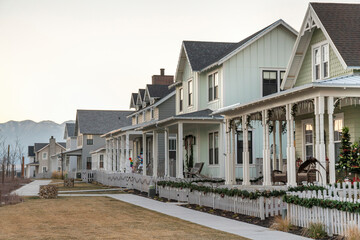Row of houses with ornamental christmas decorations at the fence and porch