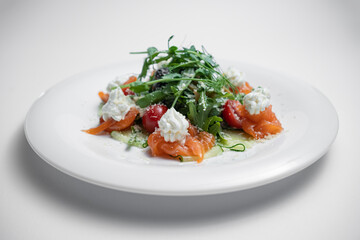 closeup of salad with salted salmon, cream cheese or arugula on white background