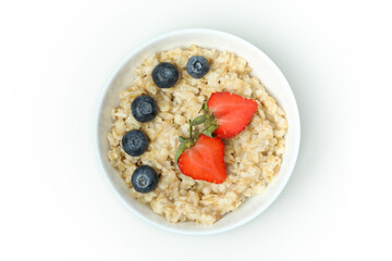 Bowl of oatmeal with tasty ingredients isolated on white background