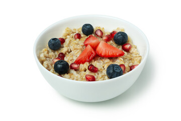 Bowl of oatmeal with tasty ingredients isolated on white background