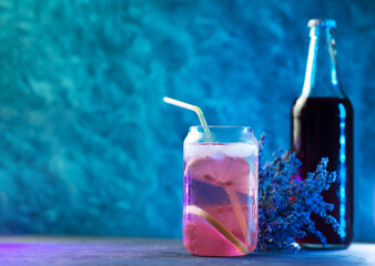 Lavender summer cold lemonade with lemon. Homemade Lavender syrup in a glass bottle, copy space