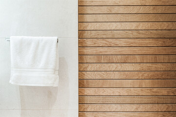 Modern wooden bathroom interior with white tile and towel console