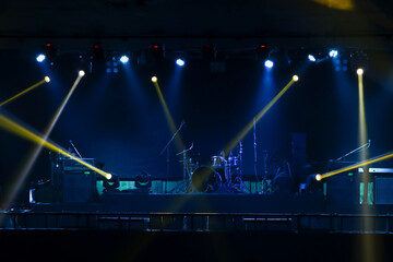 Colorful glow bright spotlights with smoke on stage in dark background, stage concert and music festival show concept.