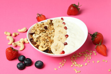 Concept of tasty eating with oatmeal on pink background