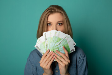 face of a frightened female with euro bills  - obrazy, fototapety, plakaty