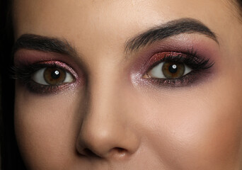 Young woman with evening makeup, closeup. Eye shadow product