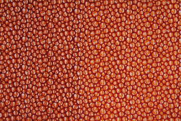 Fabric orange-red background in a grainy pattern