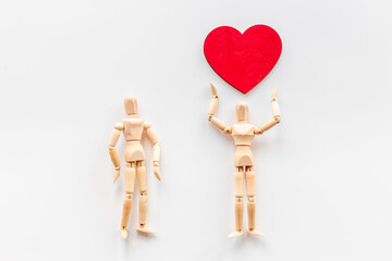 Couple of wooden mannequin figures with heart. Love and dating concept
