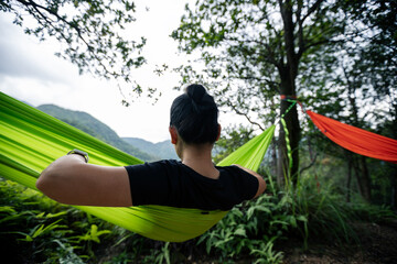 Relaxing in hammock in tropical rainforest