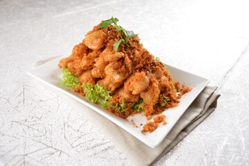Deep fried crispy golden egg plant with chicken floss appetiser platter in white background appetiser halal menu