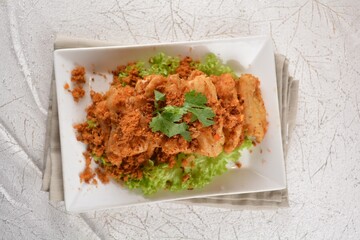 Deep fried crispy golden egg plant with chicken floss appetiser platter in white background appetiser halal menu