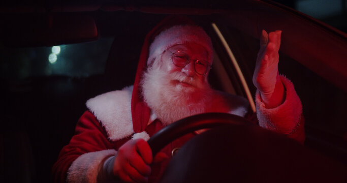 Santa Claus annoyed in car stuck in traffic.