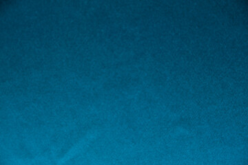 Blue silk drapery and upholstery fabric from the courtyard. Blue satin, silky fabric, wave, draperies. Beautiful textile backdrop. Close-up. Top view