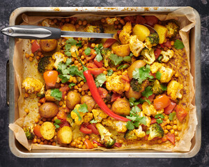 A delicious vegetarian dish found throughout India and Pakistan, with potatoes, broccoli, cauliflower baked in a metal oven dish.
