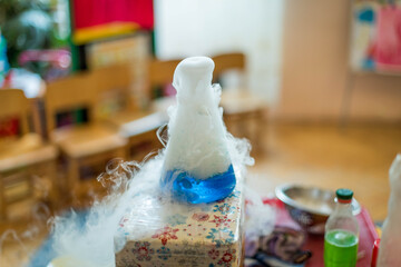 Experiments with dry ice for children. Smoke from the flask from reaction of dry ice with water,...