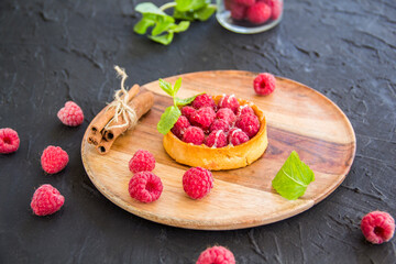 A healthy tasty dessert of cheese raspberry tart. Creative atmospheric decoration